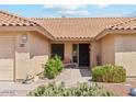 Inviting front entrance with a tile roof, desert landscaping, and walkway to the front door at 9814 W Menadota Dr, Peoria, AZ 85382
