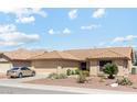 Charming single-story home with desert landscaping, a tile roof and attached two-car garage at 9814 W Menadota Dr, Peoria, AZ 85382