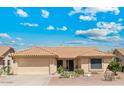 Inviting single-story home with a two-car garage and desert-style landscaping for easy upkeep at 9814 W Menadota Dr, Peoria, AZ 85382