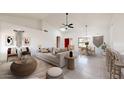 Bright living room with a vaulted ceiling, modern decor, and an open concept layout for easy living at 9814 W Menadota Dr, Peoria, AZ 85382