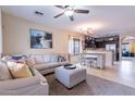 Bright, open-concept living space with comfortable seating, stylish decor, and seamless flow to kitchen at 13318 W Indianola Ave, Litchfield Park, AZ 85340