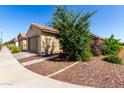 A cozy single-level residence complemented by xeriscaping and charming curb appeal at 14233 W Georgia Dr, Surprise, AZ 85379
