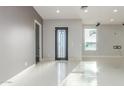Bright entryway featuring tile flooring, gray walls, and a modern front door at 14821 N 62Nd Ave, Glendale, AZ 85306