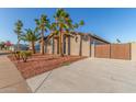 Corner lot property with desert landscaping, private drive, and a gated carport at 14821 N 62Nd Ave, Glendale, AZ 85306