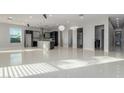 Open living space with tile flooring, modern lighting, and a view of the kitchen at 14821 N 62Nd Ave, Glendale, AZ 85306