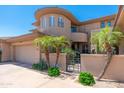 Beautiful home exterior boasts unique architecture, desert landscaping and gated entrance at 15240 N Clubgate Dr # 160, Scottsdale, AZ 85254