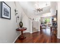 Elegant foyer showcases hardwood floors, a curved staircase, and views into the living spaces at 15240 N Clubgate Dr # 160, Scottsdale, AZ 85254