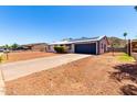 This charming ranch-style home features solar panels and xeriscape landscaping for low maintenance at 1733 W Surrey Ave, Phoenix, AZ 85029