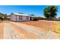 This is a nice ranch-style home that boasts a long driveway, xeriscape landscaping, and mountain views at 1733 W Surrey Ave, Phoenix, AZ 85029