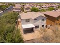 Aerial view showcasing a home with desert landscaping and backyard patio in a neighborhood at 17433 W Holland Ln, Surprise, AZ 85388