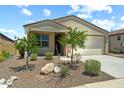Inviting single-story home featuring a two-car garage and charming desert landscaping at 18032 W Muirwood Dr, Goodyear, AZ 85338