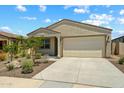 Charming single-story home with a low maintenance desert rock garden at 18032 W Muirwood Dr, Goodyear, AZ 85338