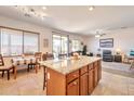 Open kitchen view with granite island, dining area, and a seamless transition to the living room at 18118 N Smith Dr, Maricopa, AZ 85139