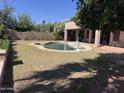 Backyard showcasing a refreshing private pool, grassy area and covered patio at 20609 N 57Th Dr, Glendale, AZ 85308
