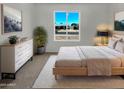 Serene main bedroom with neutral tones, a large window, soft carpet, and coordinated furnishings for a calming space at 2127 W Marco Polo Rd, Phoenix, AZ 85027