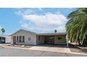 Exterior of single story home with carport and desert landscaping at 2400 E Baseline Ave # 197, Apache Junction, AZ 85119
