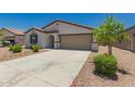 Well-maintained single-story home with a desert landscape, two-car garage, and a welcoming covered entry at 25539 W Gwen St, Buckeye, AZ 85326