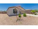 Charming single-story home with a desert front yard, attached two-car garage, and neutral exterior paint at 25539 W Gwen St, Buckeye, AZ 85326