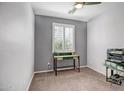 Cozy bedroom with neutral tones, a window, and a desk at 26141 N 133Rd Ave, Peoria, AZ 85383