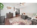Spacious living room featuring hardwood floors, a stylish rug, and a comfortable sofa at 307 W Piute Ave, Phoenix, AZ 85027
