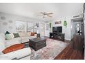 Bright and inviting living room with hardwood floors, modern decor, and a cozy sectional sofa at 307 W Piute Ave, Phoenix, AZ 85027