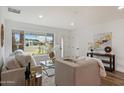 Bright and airy living room features stylish decor and large window overlooking the front yard at 3707 E Amelia Ave, Phoenix, AZ 85018