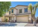 Beautiful two-story home featuring a spacious driveway, attached two-car garage, and covered entryway at 3719 E Longhorn St, San Tan Valley, AZ 85140