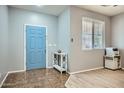 Bright foyer with a light blue front door, tile flooring, and a decorative console table at 3719 E Longhorn St, San Tan Valley, AZ 85140