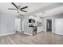Open kitchen with white cabinets, stainless steel appliances, and stylish gray flooring at 3913 W Sherman St, Phoenix, AZ 85009