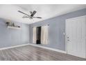 Inviting living room featuring sleek gray flooring, a modern ceiling fan, and natural light at 3913 W Sherman St, Phoenix, AZ 85009