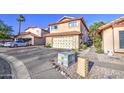 Home exterior featuring a two-car garage, low maintenance desert landscaping, and a red tile roof at 4545 N 67Th Ave # 1101, Phoenix, AZ 85033