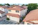 Two-story home featuring a clay tile roof, light stucco, an attached garage and well-kept landscaping at 4545 N 67Th Ave # 1101, Phoenix, AZ 85033