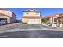 Two-story home featuring a two-car garage, desert landscaping, and a red tile roof at 4545 N 67Th Ave # 1101, Phoenix, AZ 85033