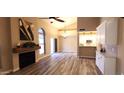 Inviting living room featuring wood-look floors, a fireplace, and a view into a brightly lit kitchen at 5640 E Bell Rd # 1047, Scottsdale, AZ 85254