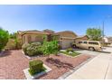 Inviting home with desert landscaping, a two-car garage, and a charming facade at 6620 S 16Th Dr, Phoenix, AZ 85041
