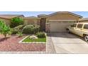 Single-Gathering home features a well-manicured front yard, a two-car garage, and stone pillars at 6620 S 16Th Dr, Phoenix, AZ 85041