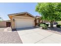 Attractive home with a well-manicured lawn, mature landscaping, and convenient two-car garage enhancing its curb appeal at 7050 S Fawn Ave, Gilbert, AZ 85298