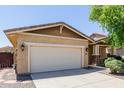 Home's two-car garage with stone veneer pillars offers ample parking and storage space at 7050 S Fawn Ave, Gilbert, AZ 85298