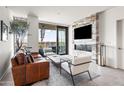 Modern living room with a decorative fireplace and sliding glass doors to the balcony at 7180 E Kierland Blvd # 811, Scottsdale, AZ 85254