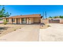 Inviting single-story home with a covered carport and spacious driveway at 7360 N 38Th Dr, Phoenix, AZ 85051