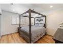 Bedroom with a four-poster bed, hardwood floors, and a window with shutters at 7430 E Chaparral Rd # A222, Scottsdale, AZ 85250