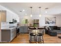 Modern kitchen with white and gray cabinets, stainless appliances, and an island with barstool seating at 7430 E Chaparral Rd # A222, Scottsdale, AZ 85250