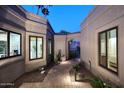 Charming courtyard with pavers, lush plants, and inviting views into the home's bright and airy interior at 7596 N Via De La Siesta --, Scottsdale, AZ 85258