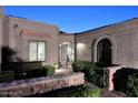 Inviting entrance with beautiful stonework, an iron gate, and lush landscaping, creating a warm and welcoming atmosphere at 7596 N Via De La Siesta --, Scottsdale, AZ 85258