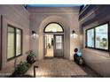 Inviting front entrance showcasing an arched doorway, elegant lighting, and stylish doors at 7596 N Via De La Siesta --, Scottsdale, AZ 85258