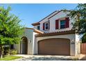 Charming two-story home featuring desert landscaping, a spacious driveway, and a two-car garage at 919 W Yellowstone Way, Chandler, AZ 85248