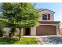 Charming two-story home featuring desert landscaping, a spacious driveway, and a two-car garage at 919 W Yellowstone Way, Chandler, AZ 85248