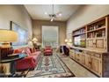 Cozy living room with comfortable seating, built-in shelving, and natural light from a window at 9534 E Monument Dr, Scottsdale, AZ 85262