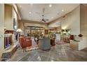 Spacious living room featuring a fireplace, tiled flooring, comfortable seating, and large windows with views to the outside at 9534 E Monument Dr, Scottsdale, AZ 85262