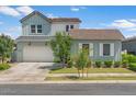 Inviting two-story home with a three-car garage, manicured lawn, and charming curb appeal at 10144 E Toledo Ave, Mesa, AZ 85212